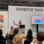 laura speaking at a podium at the health and wellbeing at work event