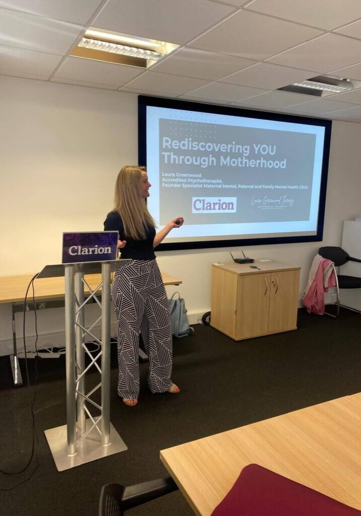 laura greenwood giving a talk in front of presentation screen